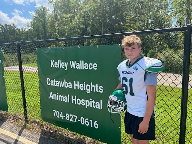 CHAH Sponsors Belmont Middle School Athletics Dr. Wallace's son next to the sponsorship sign